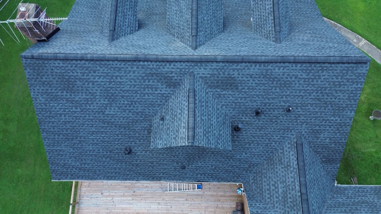 Completed charcoal shingle roof with rear deck